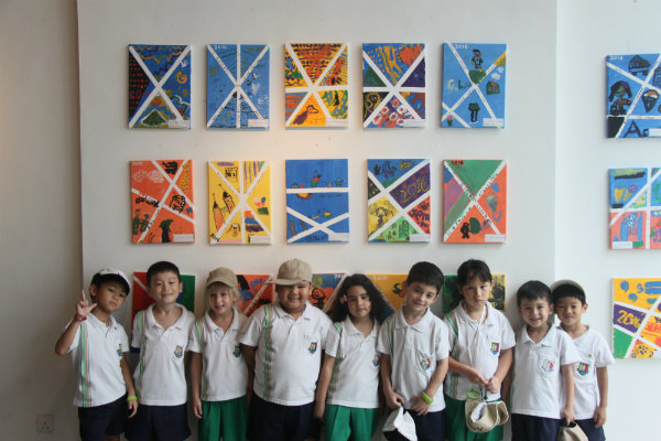 Children posing with their artwork.