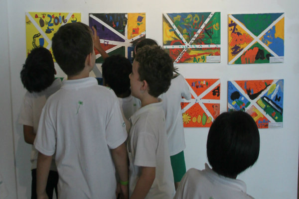 Children looking at awe at their artwork. 